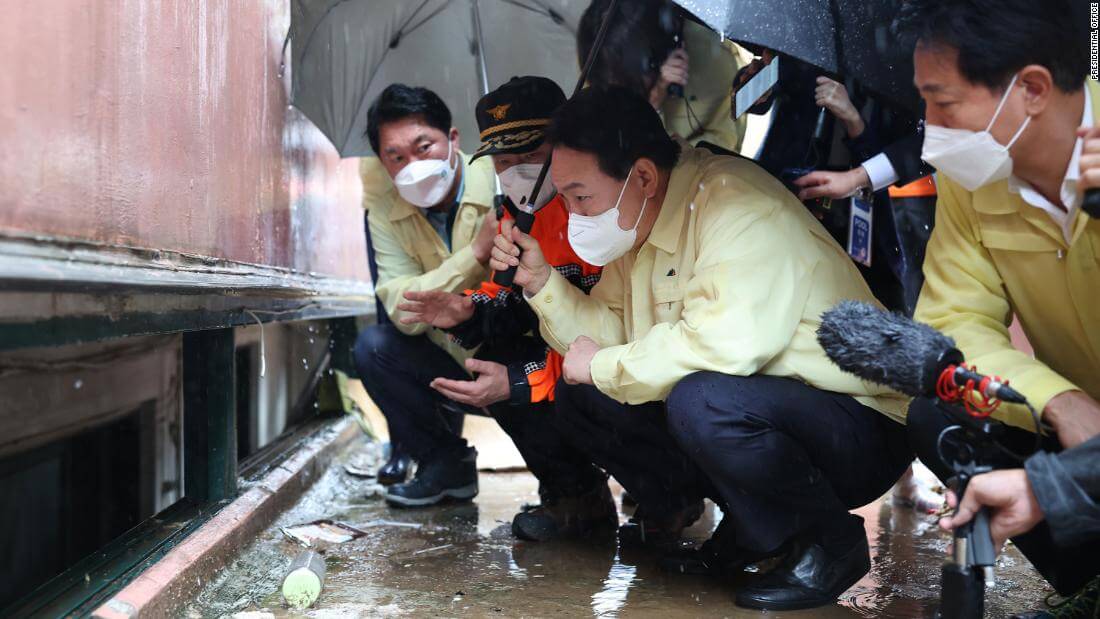 South Korean President Yoon Suk Yeol visiting a flooded semi-basement.