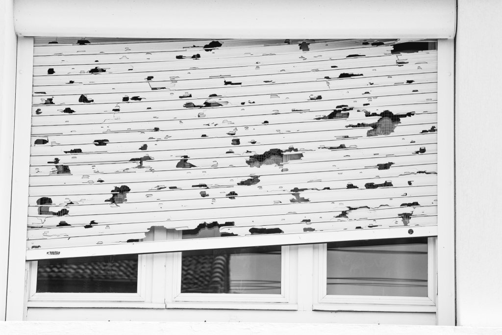Hail damage on window shutters.