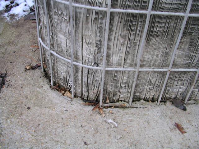 A/C condenser cemented to the ground
